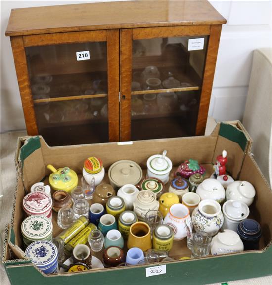 A collection of Colmans mustard and other lidded ceramic mustard pots contained in a small 2 door maple cabinet (26)